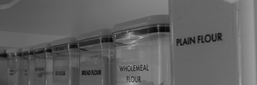 Black and white photo of my pantry shelf of flours