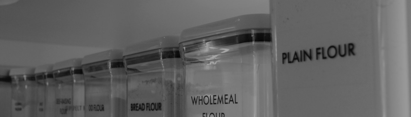 Black and white photo of my pantry shelf of flours