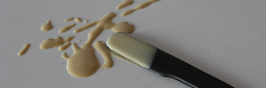 Splatter of tahini with ceramic serving knife