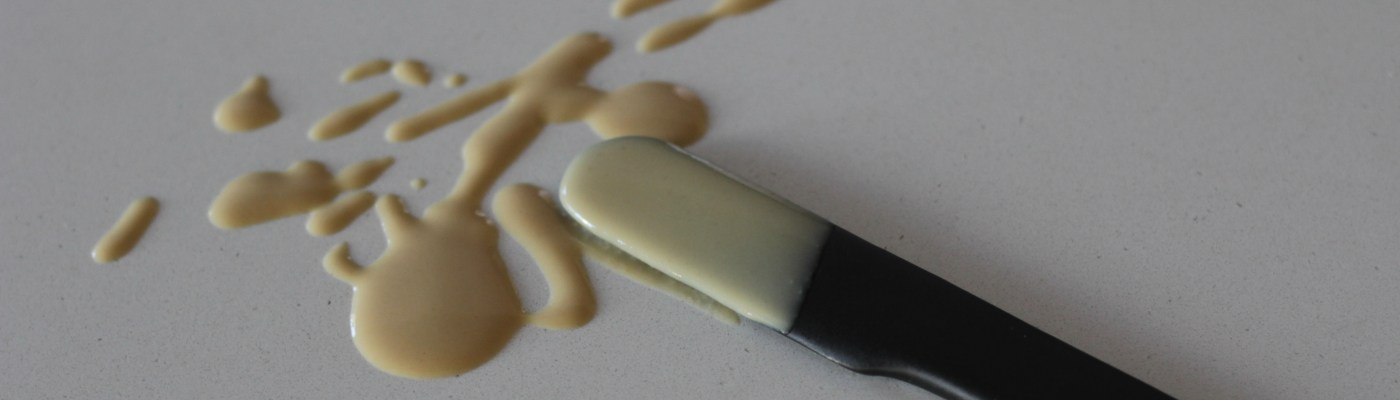Splatter of tahini with ceramic serving knife