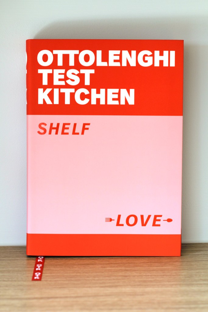 Front cover of a cookbook, with thick bands of red and pink and the text 'Ottolenghi Test Kitchen: Shelf Love'.